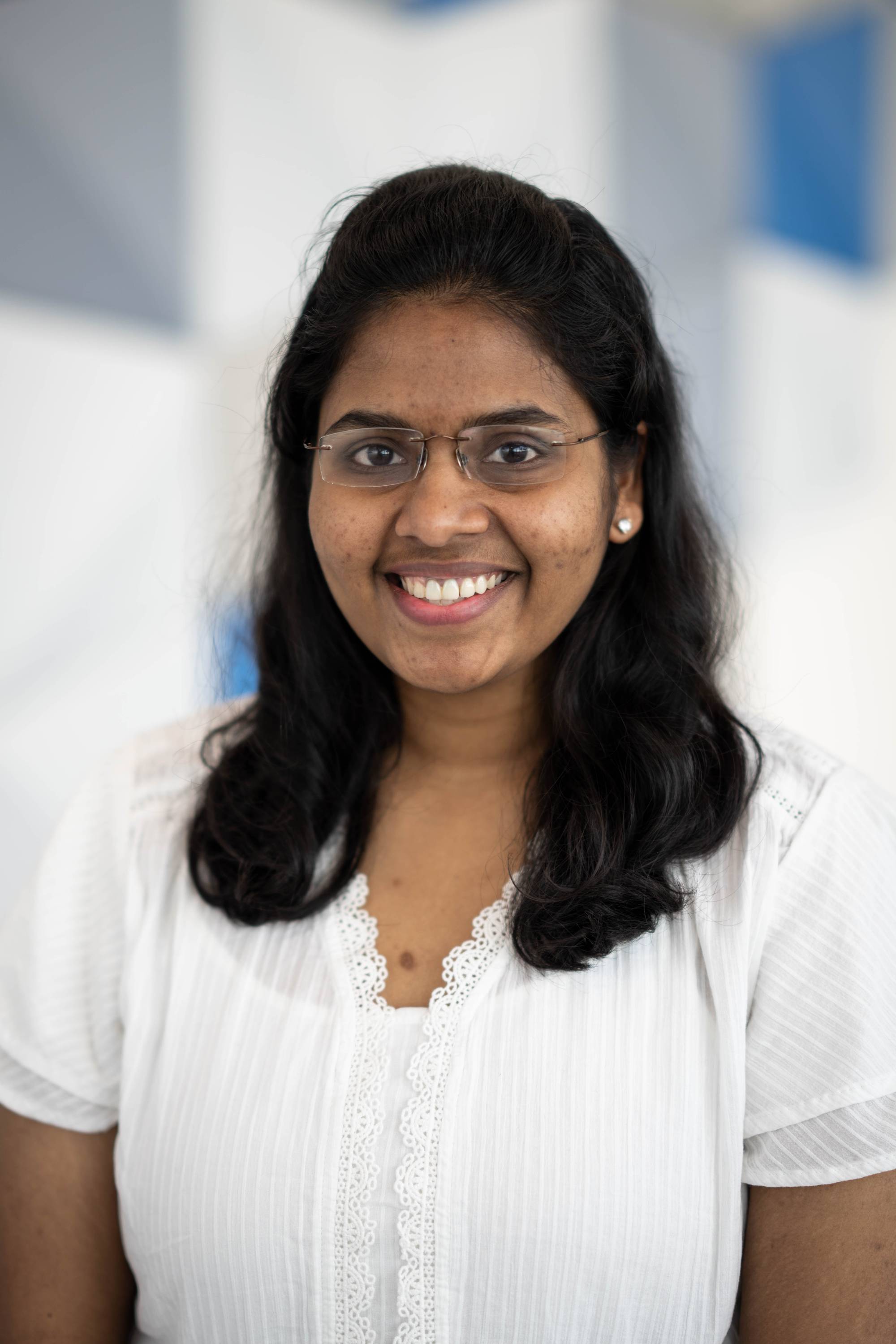 Bhavya smiles at the camera in a close up shot